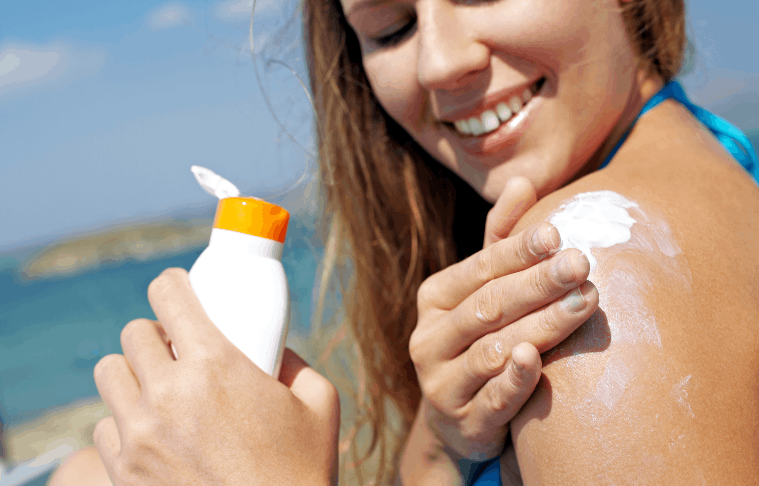 woman putting on sunscreen